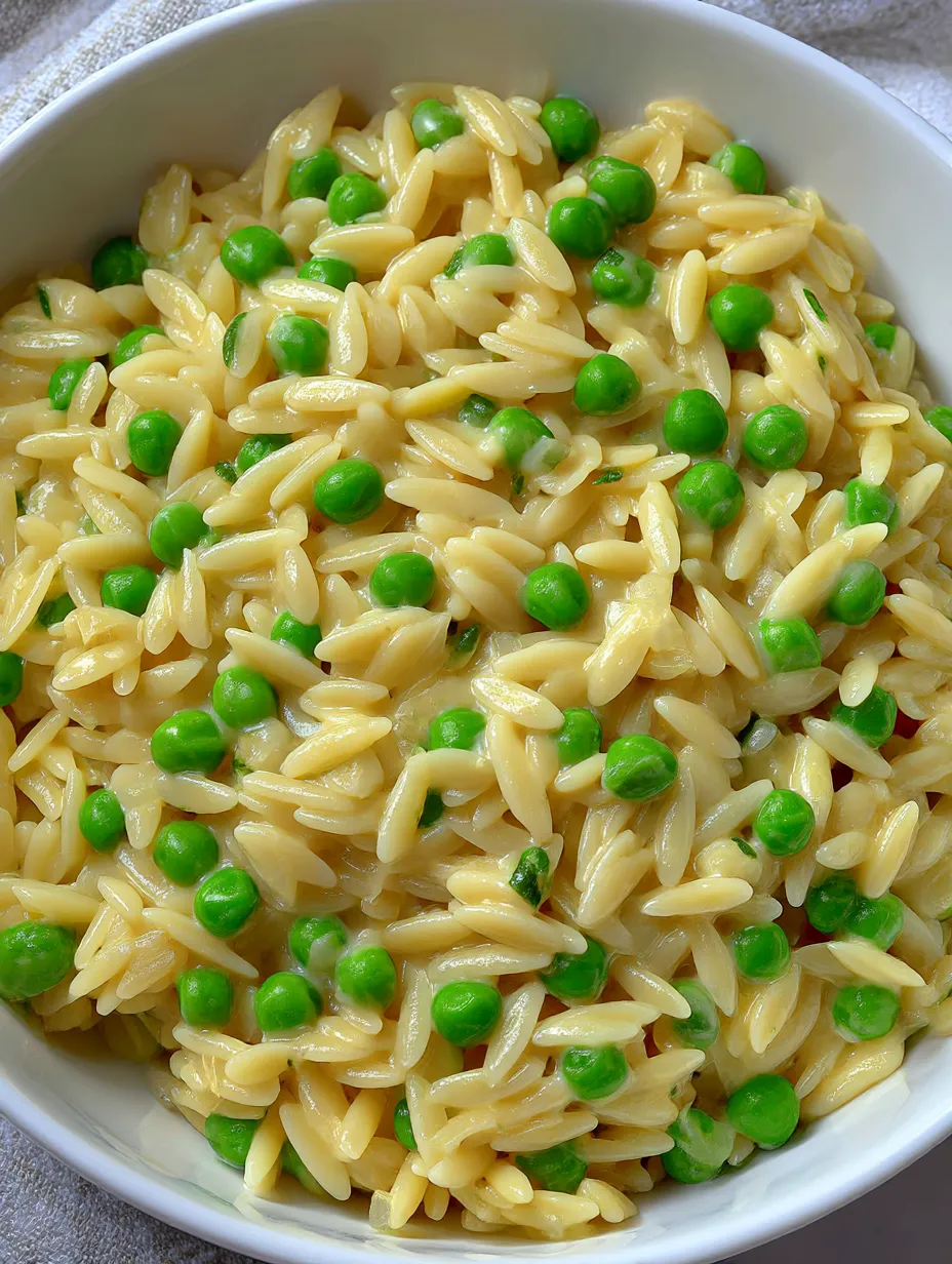 A bowl of rice, peas and Parmesan cheese.