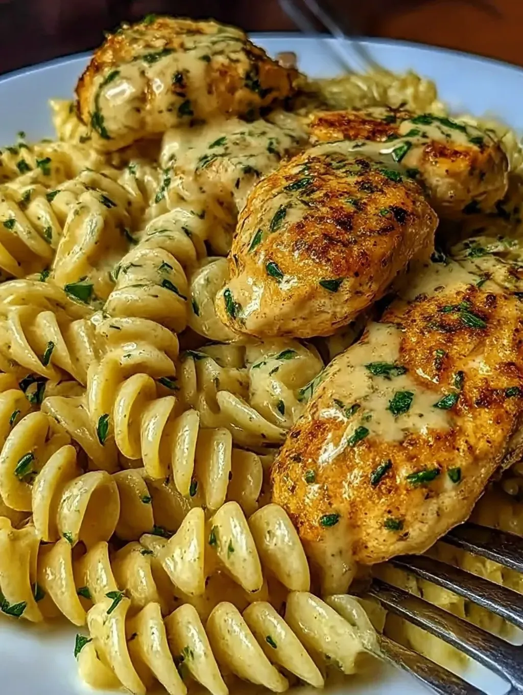 A photo of creamy Garlic Parmesan Chicken with Cheesy Twisted Pasta, ready to eat.