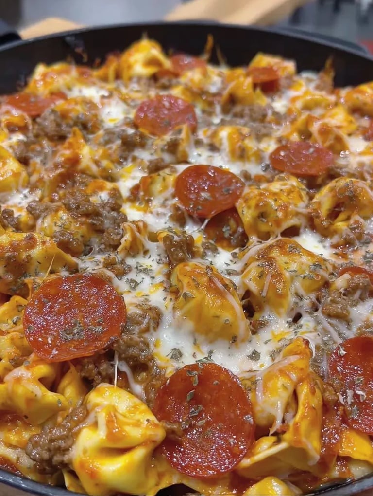 A pizza-inspired dish with pasta, tomatoes, mozzarella, and pepperoni.