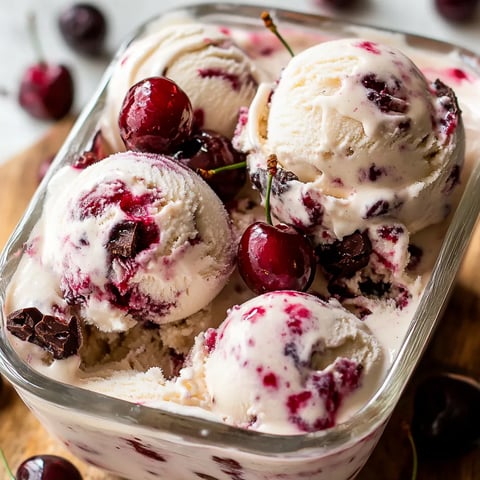 Rich cherry ice cream topped with cherries and chocolate, inspired by Black Forest flavors.