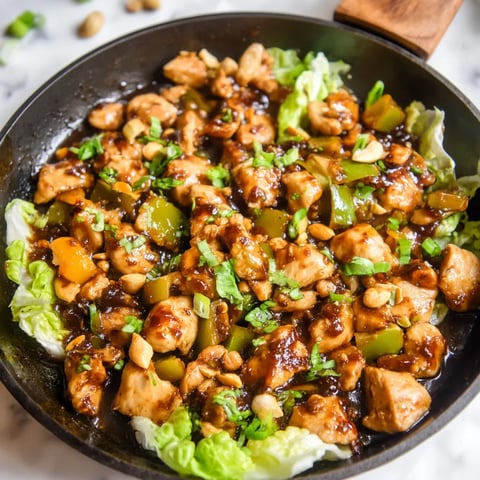 A pan of chicken stir fry with vegetables.