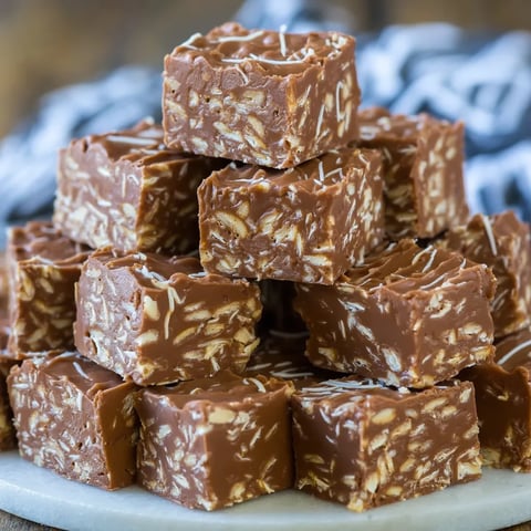 A stack of brownies on a plate.