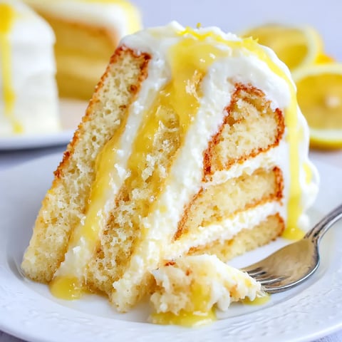 A chewy, moist piece of lemon curd cake on a plate.
