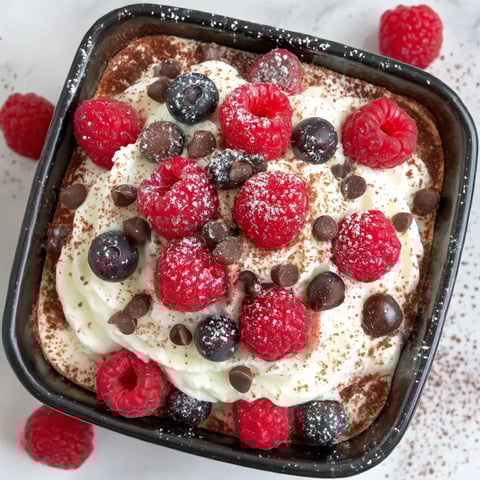 A close up of a dessert with raspberries and chocolate.