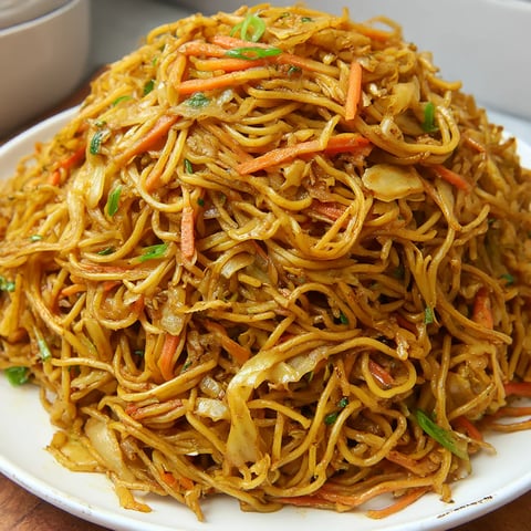 Noodles piled high with lots of bright veggies.