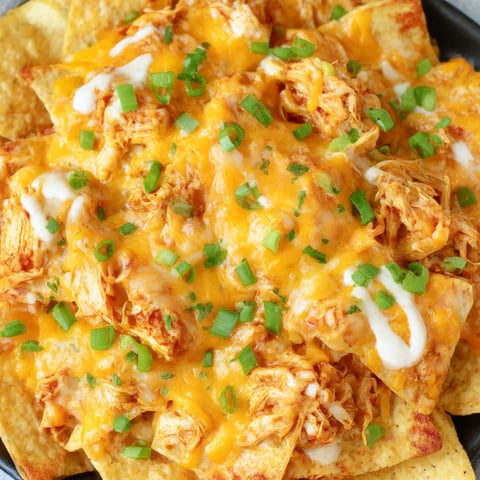 Loaded buffalo chicken nachos served on a dish.