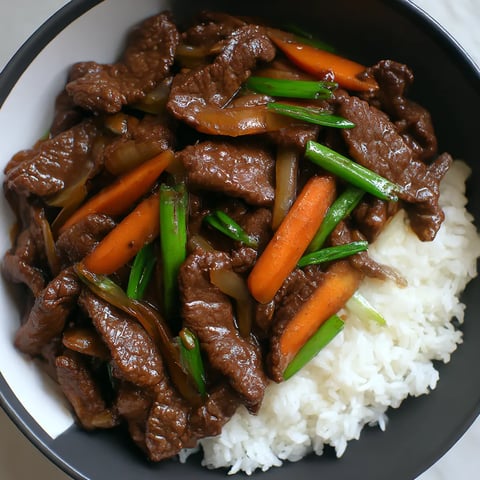 Chinese beef and onion stir-fry in a bowl.
