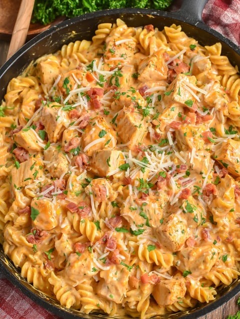 Bowl of pasta loaded up with onions.