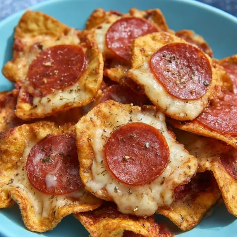 A plate covered in pizza chips made from just cheese and pepperoni.