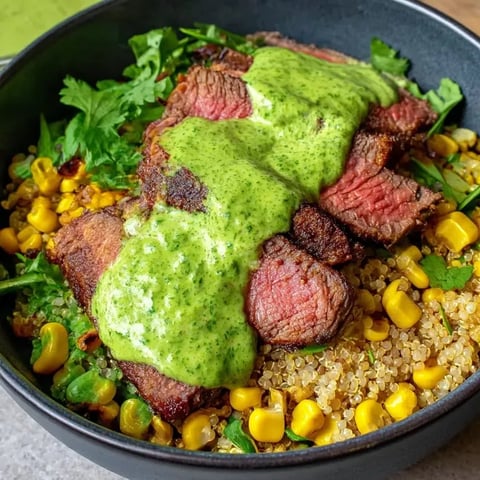 A bowl with beef, potatoes, cilantro and mayo.