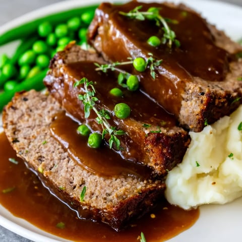 A platter holding steak, peas, and potatoes.