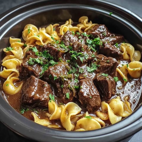 A bowl packed with noodle soup and crispy noodles on top.