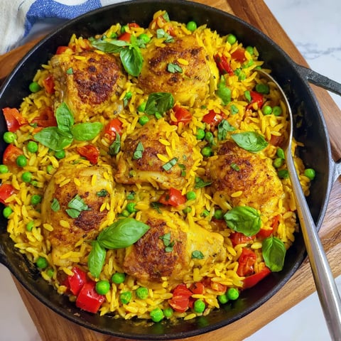 A bowl with rice and chicken, topped with some spinach.