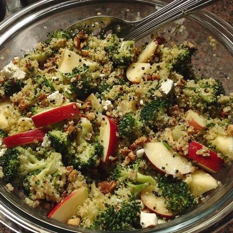 A jar loaded with nuts, fruit, and veggies—think broccoli, walnuts, coconut, almonds all mixed up.